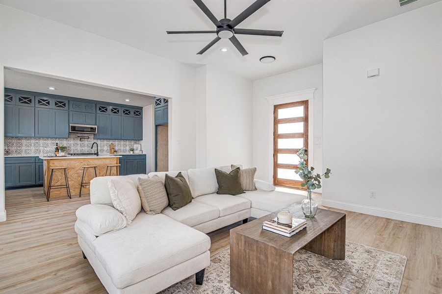 Living area featuring light wood finished floors, recessed lighting, and a ceiling fan