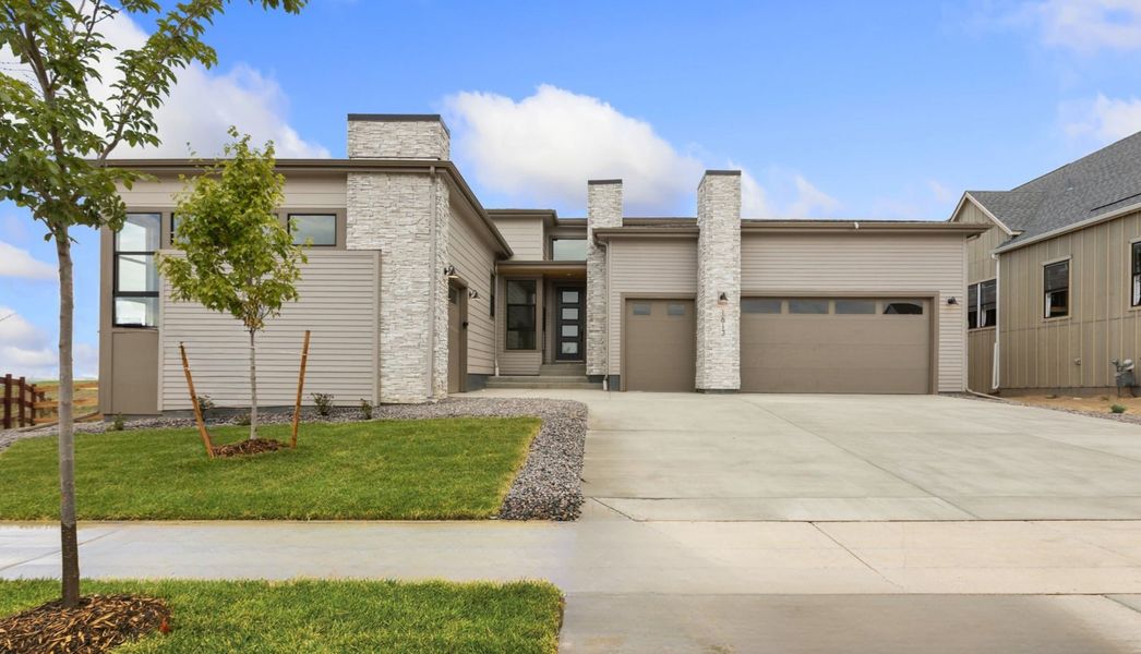 Front exterior of a new home in RainDance, Windsor, CO, highlighting curb appeal (Image 1). Front exterior of a new home in RainDance, Windsor, CO, highlighting curb appeal (Image 1).