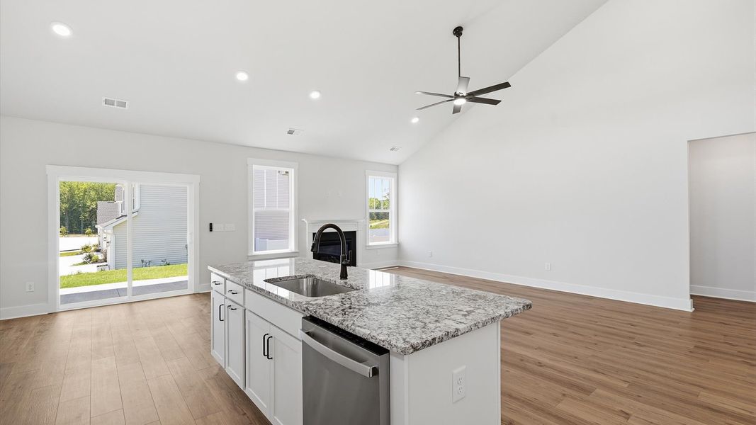 Vibrant kitchen layout with a center island, refined finishes, and open-concept flow Vibrant kitchen layout with a center island, refined finishes, and open-concept flow