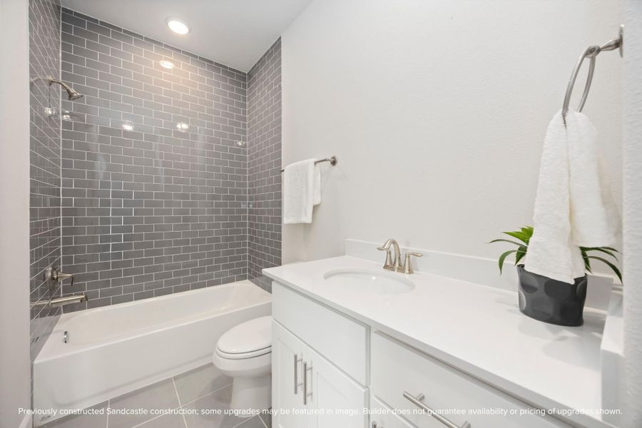 Timeless design and neutral finishes converge in the hall bathroom, crafting an elegant space for daily routines. Timeless design and neutral finishes converge in the hall bathroom, crafting an elegant space for daily routines.