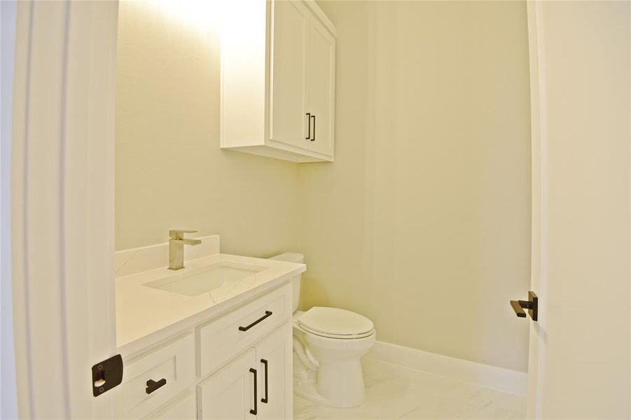 Bathroom with tile patterned floors, vanity, and toilet