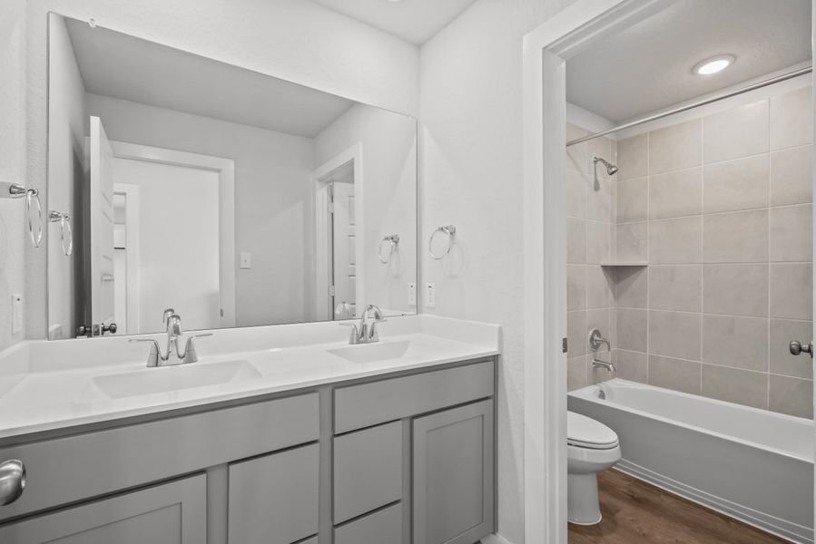 A bathroom with a tub sink and toilet.