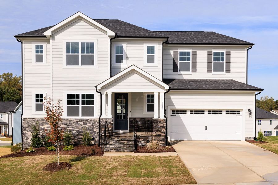 Front exterior of a new home in High Grove Oaks, Fuquay Varina, NC, highlighting curb appeal (Image 1).