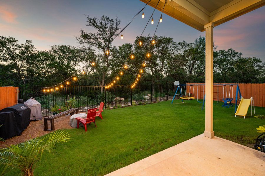 A verdant backyard with string lights, perfect for evening gatherings or playtime. A verdant backyard with string lights, perfect for evening gatherings or playtime.