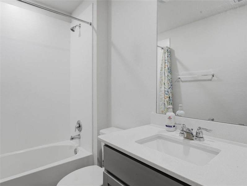 Clean lines and stone counters define this modern full bathroom. Clean lines and stone counters define this modern full bathroom.