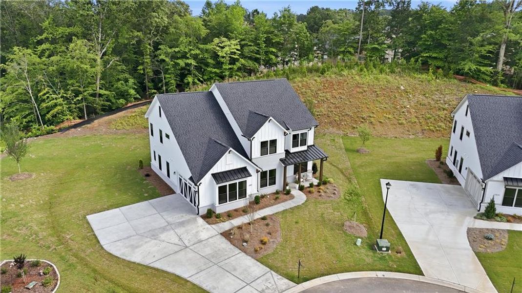 Front exterior of a new home in Sterling Pointe, Cumming, GA, highlighting curb appeal (Image 32). Front exterior of a new home in Sterling Pointe, Cumming, GA, highlighting curb appeal (Image 32).