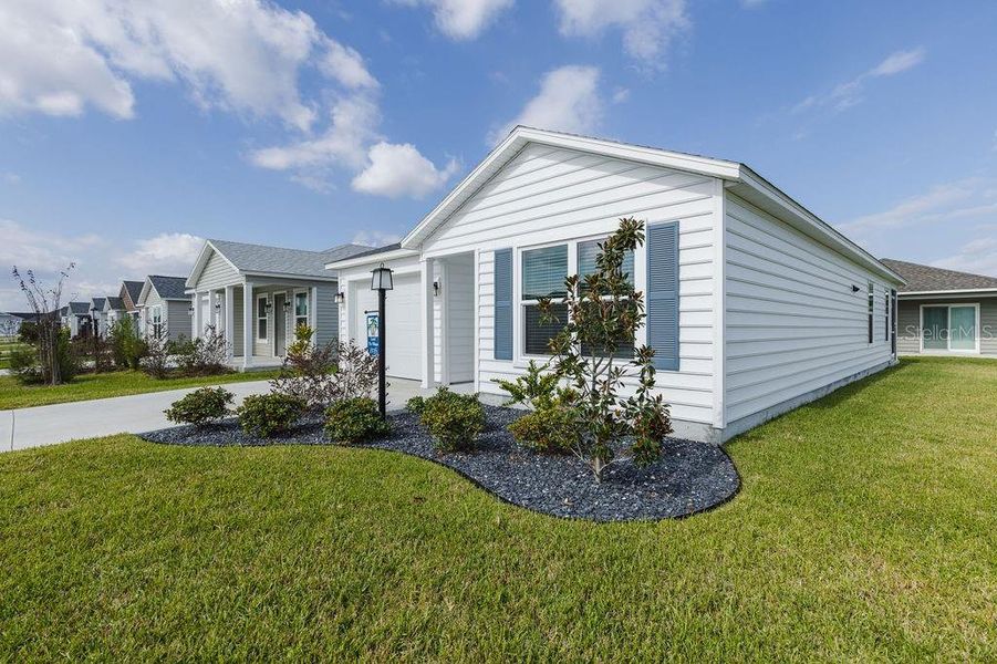 Front exterior of a new home in , The Villages, FL, highlighting curb appeal (Image 2).