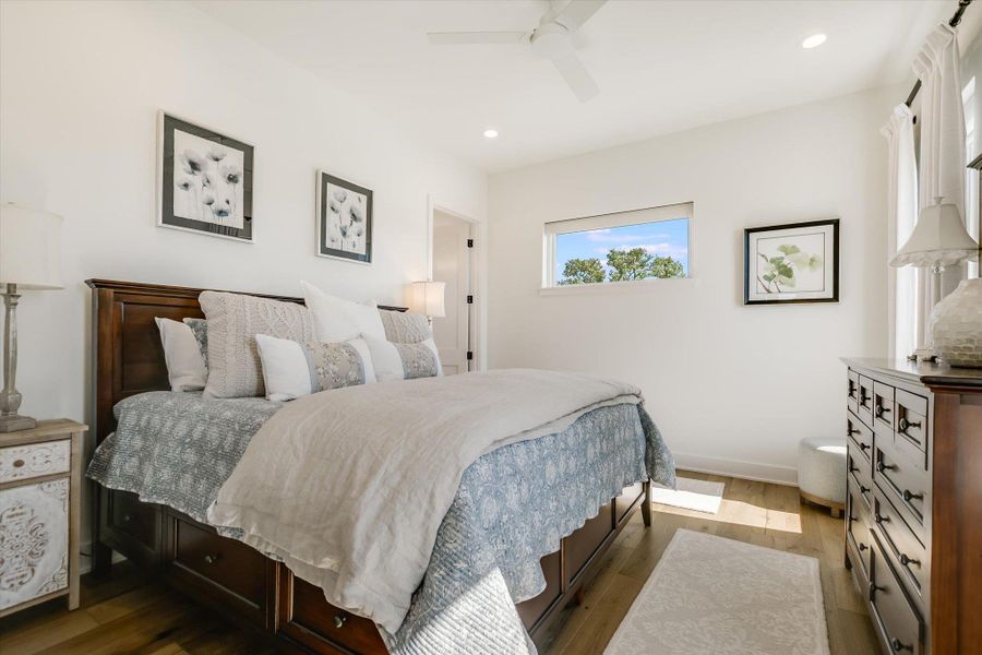 Bedroom with dark wood finished floors, recessed lighting, a ceiling fan, and baseboards Bedroom with dark wood finished floors, recessed lighting, a ceiling fan, and baseboards