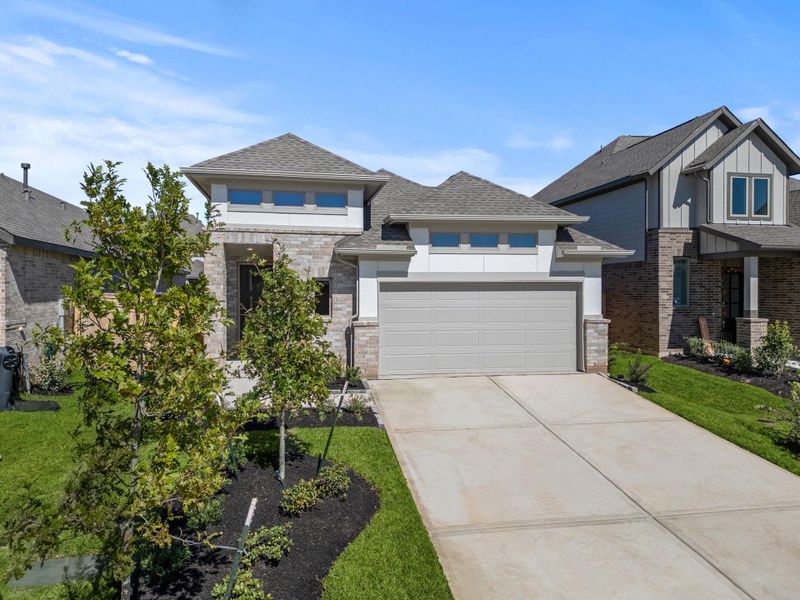Front exterior of a new home in Grand Central Park, Conroe, TX, highlighting curb appeal (Image 18).
