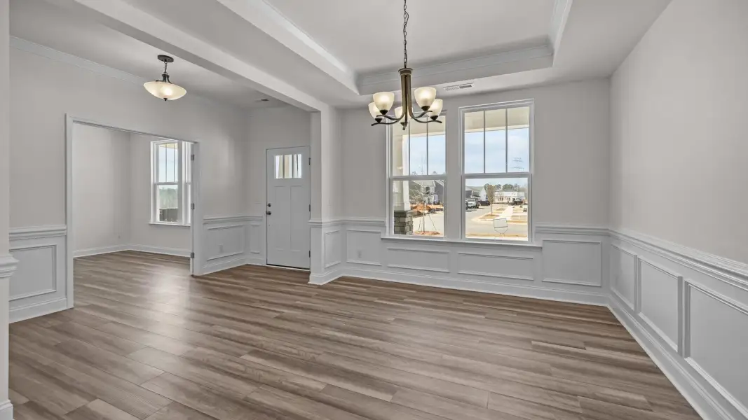 Ample and inviting entrance, dining room, and study, with premium finishes, in the Norris Design by DRB Homes in York, SC Ample and inviting entrance, dining room, and study, with premium finishes, in the Norris Design by DRB Homes in York, SC