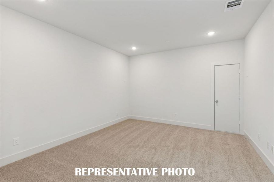 The spacious media room with adjacent game room together create the ultimate family entertainment zone!  REPRESENTATIVE PHOTO