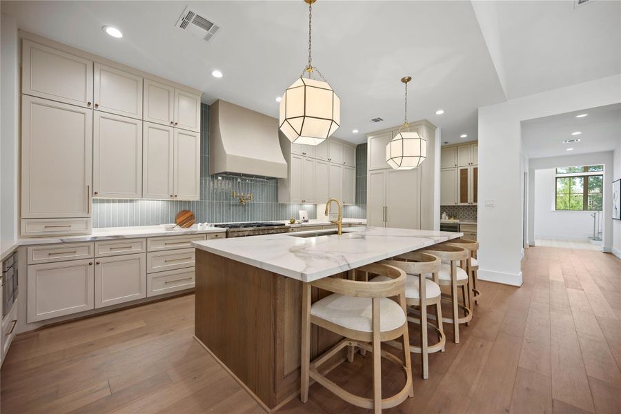 This stunning kitchen showcases a large island topped with Calacatta Macchia Vecchia quartz, offering both beauty and functionality for everyday living and entertaining. This stunning kitchen showcases a large island topped with Calacatta Macchia Vecchia quartz, offering both beauty and functionality for everyday living and entertaining.