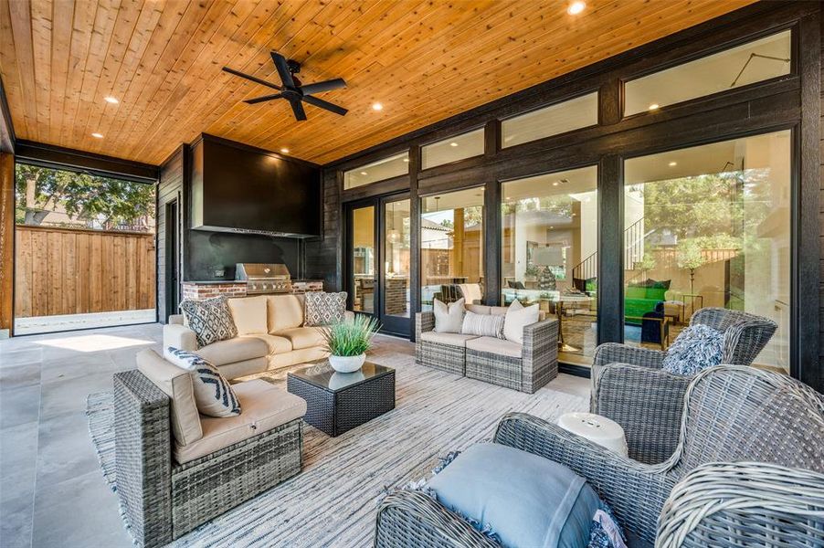 Sunroom / solarium with ceiling fan and wood ceiling