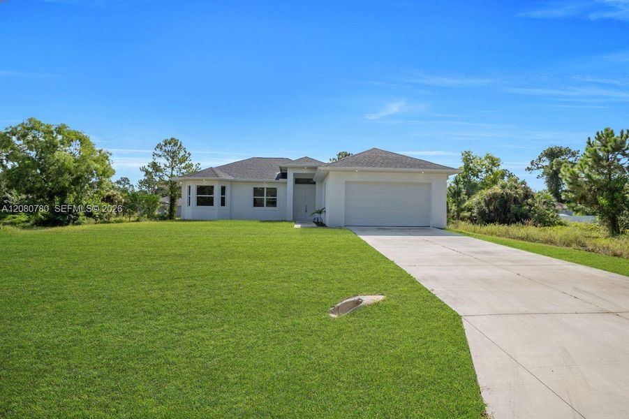 Front exterior of a new home in , Lehigh Acres, FL, highlighting curb appeal (Image 20). Front exterior of a new home in , Lehigh Acres, FL, highlighting curb appeal (Image 20).