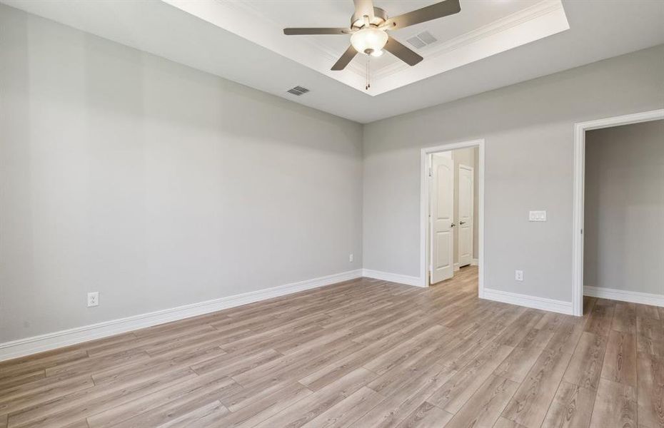 Elegant owner's suite with Tray ceiling *real home pictured