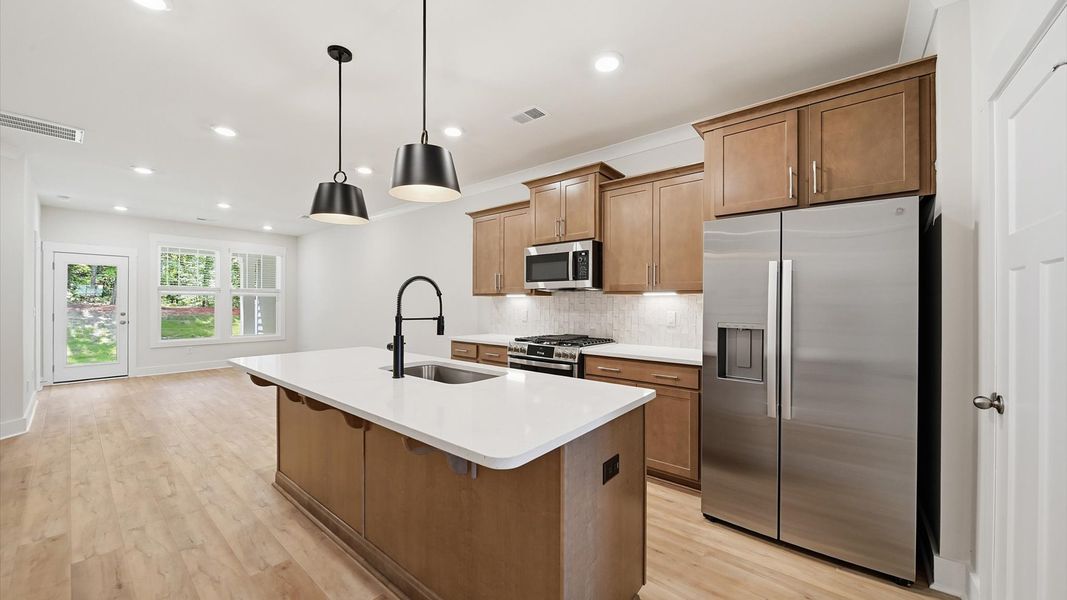 Elegant kitchen featuring a functional island and clean, current styling throughout Elegant kitchen featuring a functional island and clean, current styling throughout