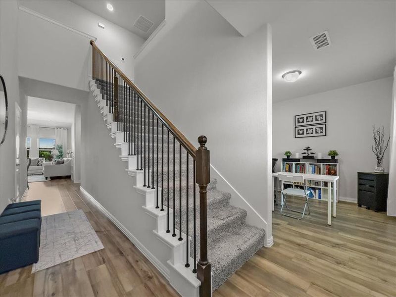 Stairway featuring light wood-type flooring