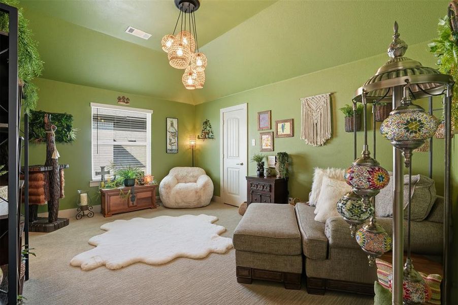 Sitting room featuring carpet floors, lofted ceiling, and a chandelier Sitting room featuring carpet floors, lofted ceiling, and a chandelier