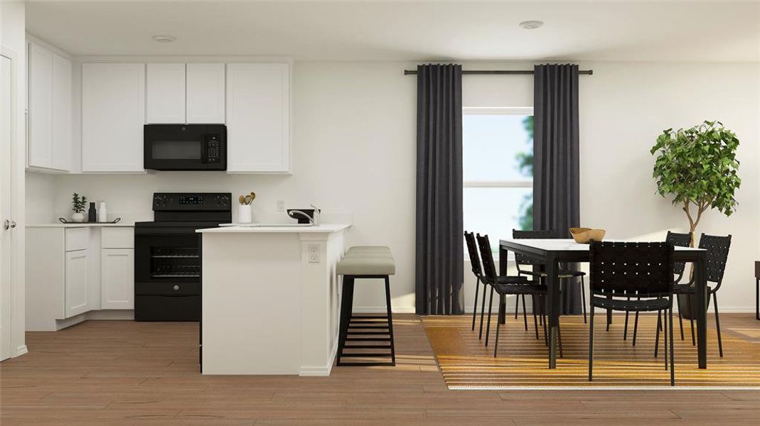 Kitchen featuring black appliances, white cabinets, and light hardwood / wood-style floors