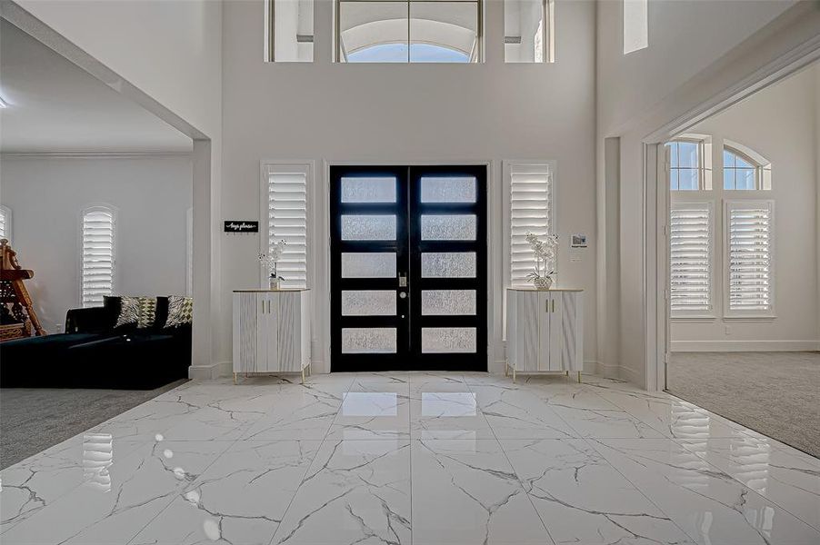 A Stunning Entrance! A modern wood and glass double door featuring water-textured glass panels, adding a perfect touch of sophistication and elegance.