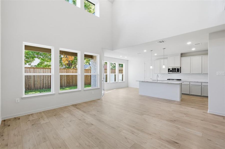 Unfurnished living room with light wood-style flooring and recessed lighting