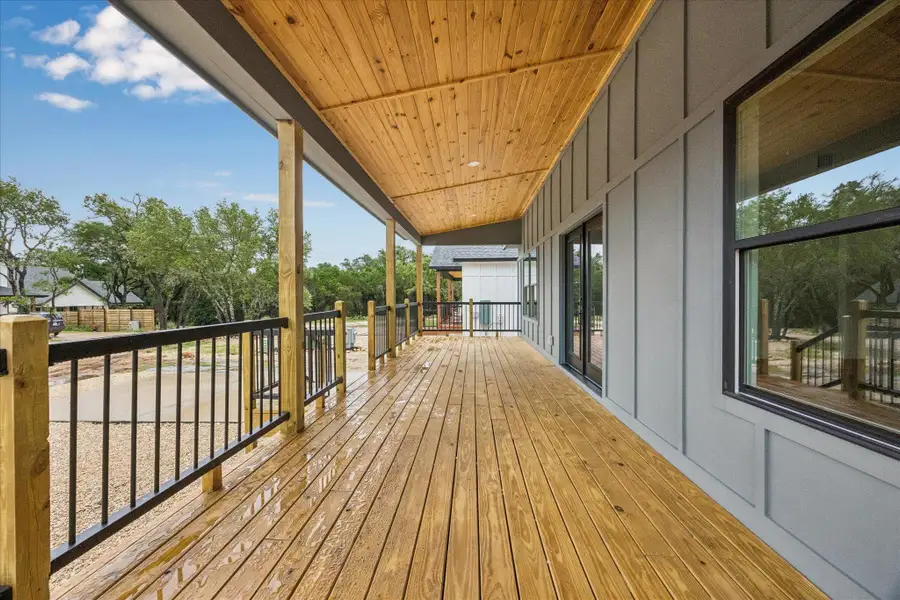 A spacious covered porch features polished wood flooring, perfect for outdoor relaxation. A spacious covered porch features polished wood flooring, perfect for outdoor relaxation.