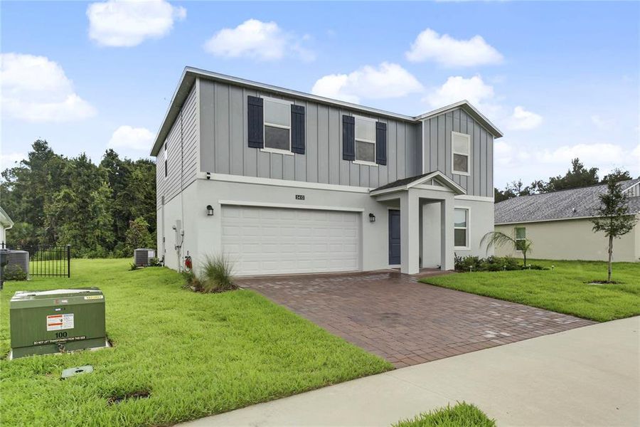 Front exterior of a new home in Providence, Davenport, FL, highlighting curb appeal (Image 1). Front exterior of a new home in Providence, Davenport, FL, highlighting curb appeal (Image 1).