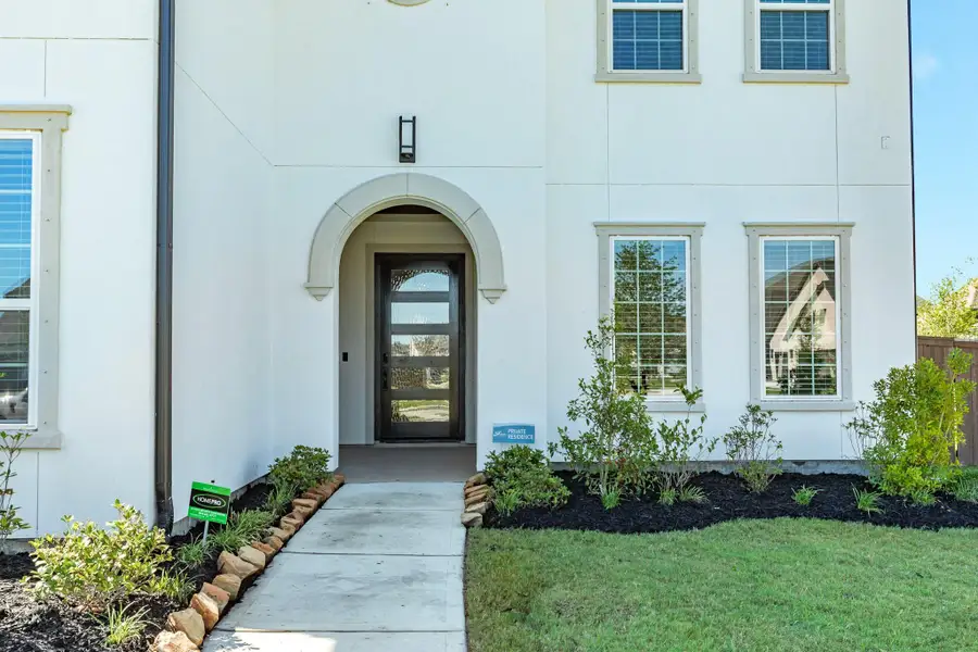 Upon entering, you are greeted by this beautiful wooden and glass 1ft door that serves as a stunning focal point, immediately establishing the home's unique character and inviting atmosphere.