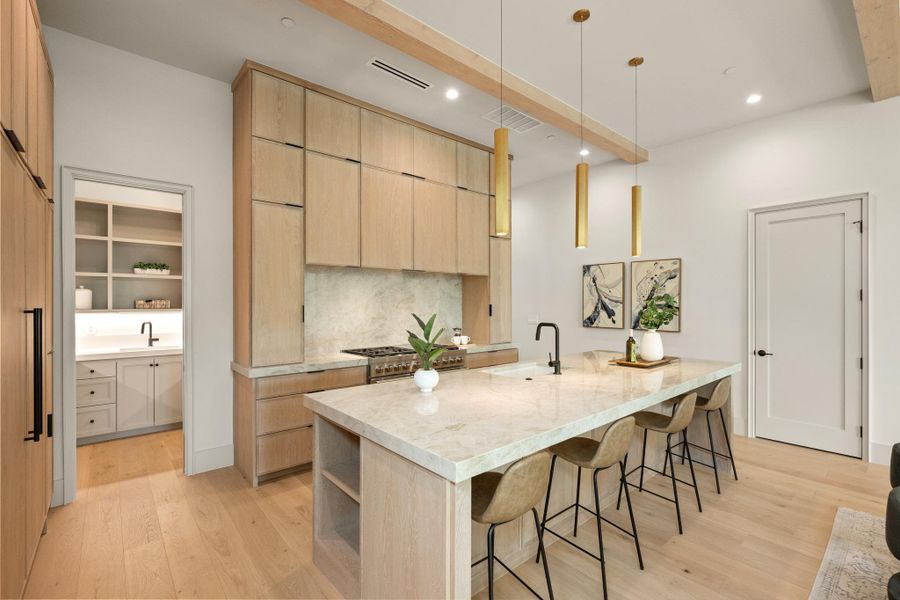 Culinary excellence awaits in this well-lit kitchen with a spacious island and gleaming countertops. Culinary excellence awaits in this well-lit kitchen with a spacious island and gleaming countertops.