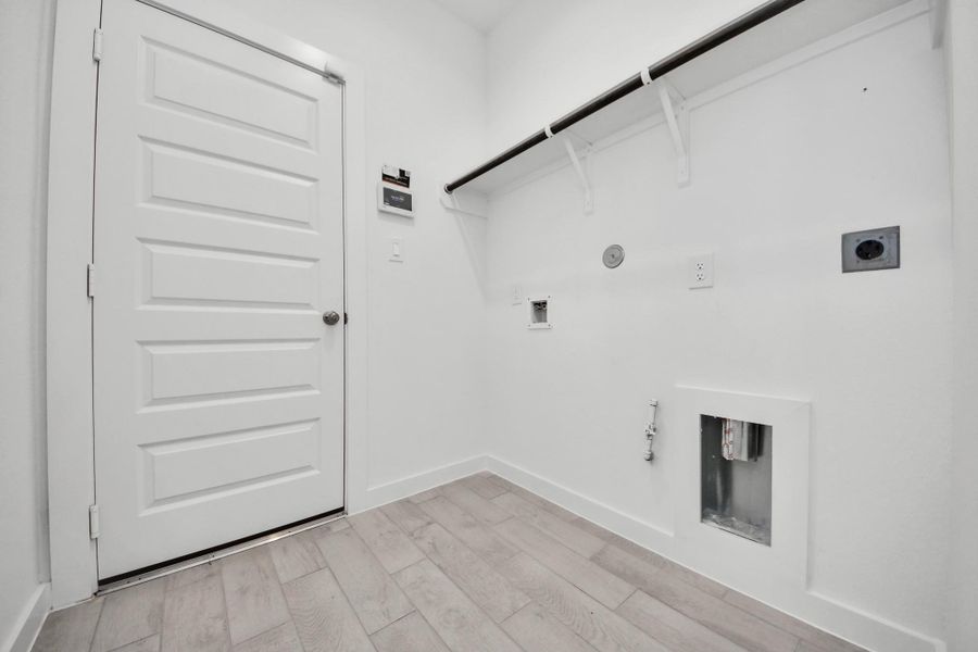 A perfect blend of functionality and comfort. Capture the essence of easy living with a first-floor laundry room, thoughtfully equipped with shelving for effortless organization. Both electric and gas connections available. A perfect blend of functionality and comfort. Capture the essence of easy living with a first-floor laundry room, thoughtfully equipped with shelving for effortless organization. Both electric and gas connections available.