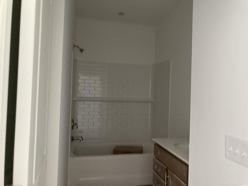 Bathroom with vanity and shower / washtub combination