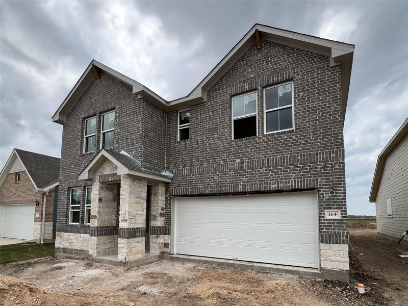 Front exterior of a new home in Rolling Glen, Hutto, TX, highlighting curb appeal (Image 1).