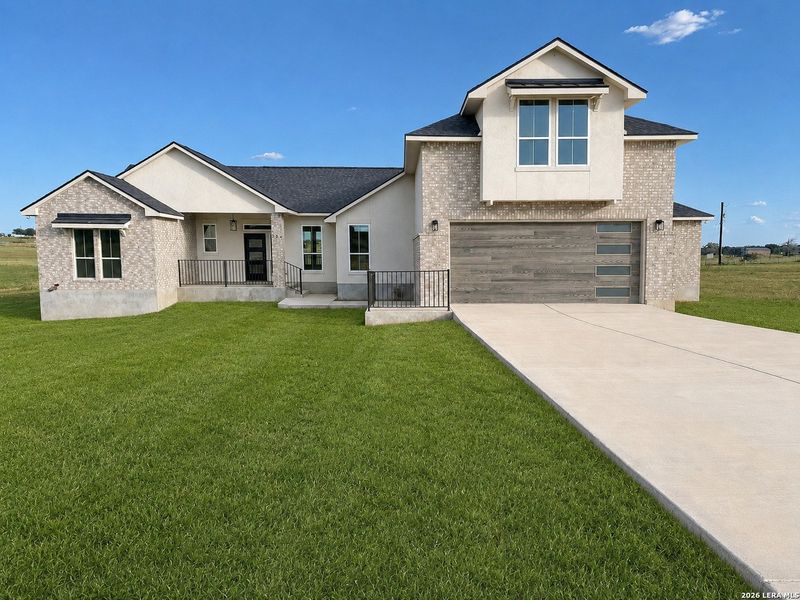 Front exterior of a new home in , La Vernia, TX, highlighting curb appeal (Image 26).