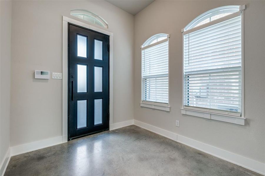 Entrance foyer featuring a healthy amount of sunlight and concrete flooring