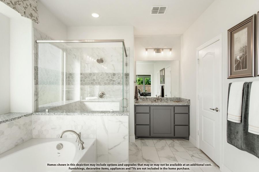 Master bathroom with soaking tub, glass-enclosed shower, gray vanity, and marble tile flooring