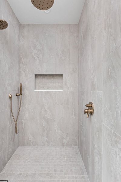 Bathroom featuring a tile shower Bathroom featuring a tile shower