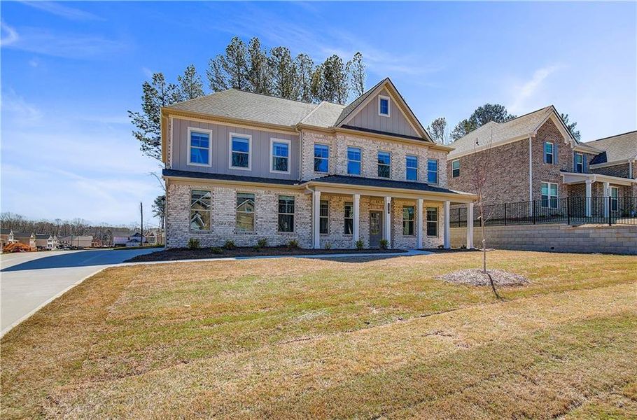 Front exterior of a new home in Cambria at Traditions, Hampton, GA, highlighting curb appeal (Image 20). Front exterior of a new home in Cambria at Traditions, Hampton, GA, highlighting curb appeal (Image 20).