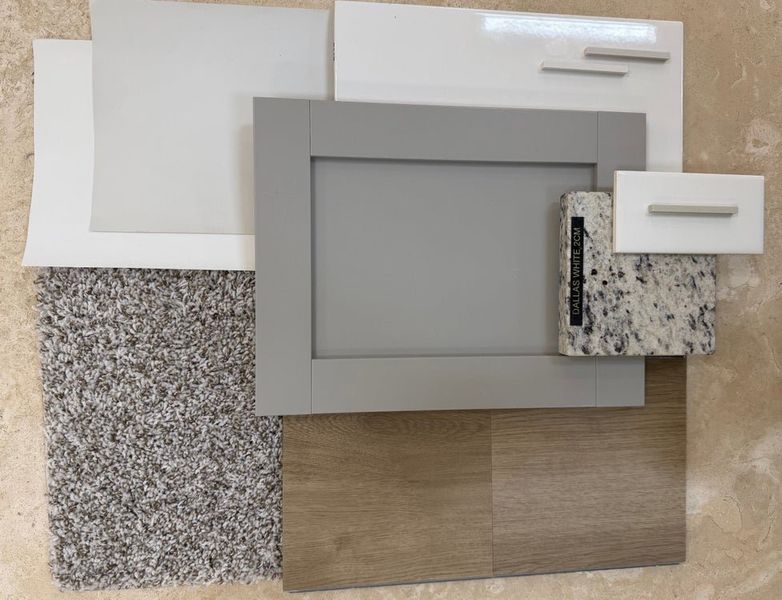 Home design material samples including gray cabinet door, white cabinets, Dallas White granite, wood flooring, and gray carpet swatches.