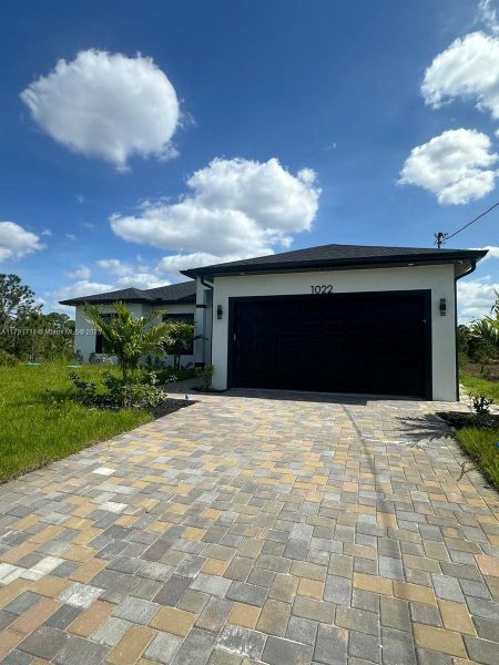 Front exterior of a new home in , Lehigh Acres, FL, highlighting curb appeal (Image 2). Front exterior of a new home in , Lehigh Acres, FL, highlighting curb appeal (Image 2).