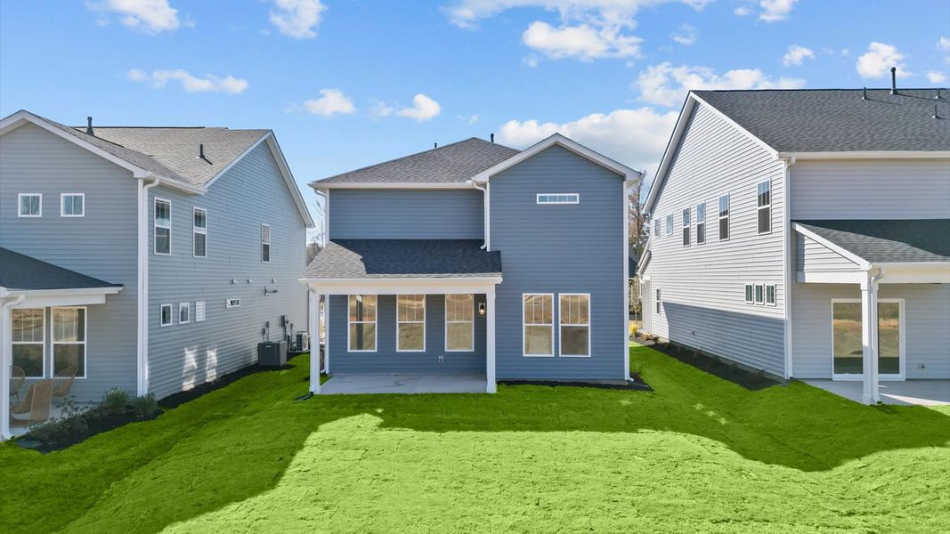 Exceptional outdoor living begins with a covered back porch in this thoughtfully designed home