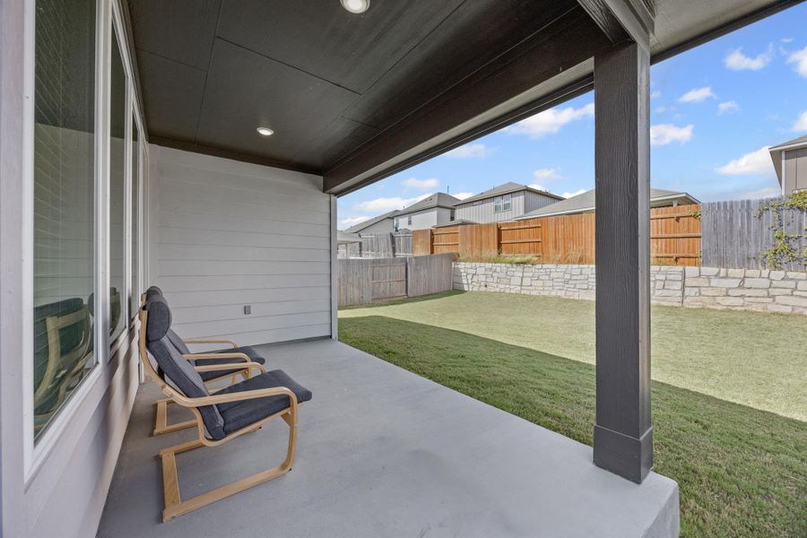 Fenced backyard with a covered patio