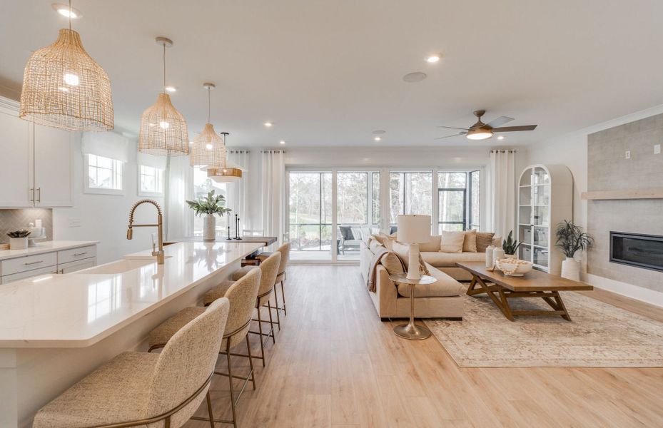 Open floorplan that connect the Kitchen and Gathering Room with a fireplace.