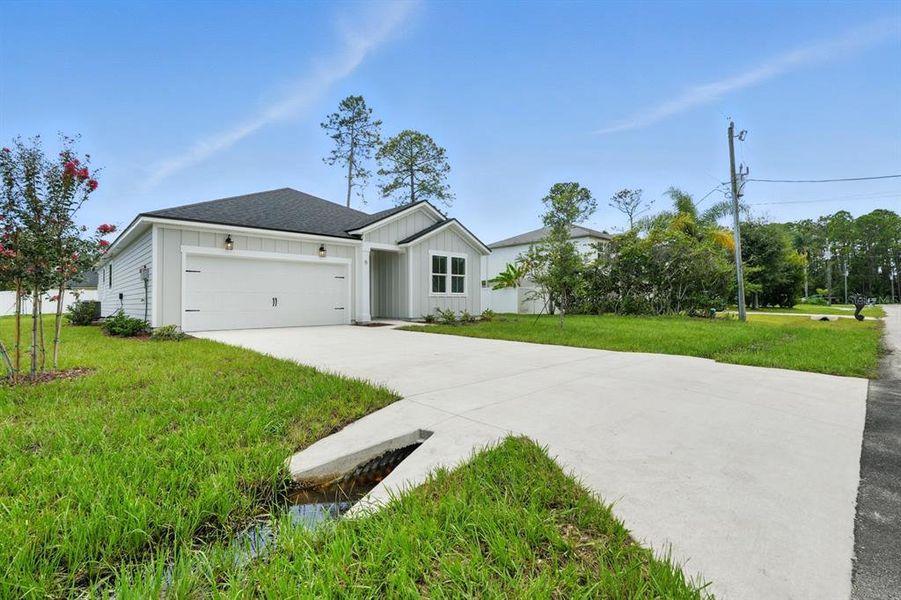 Front exterior of a new home in Palm Coast Homes, Palm Coast, FL, highlighting curb appeal (Image 2). Front exterior of a new home in Palm Coast Homes, Palm Coast, FL, highlighting curb appeal (Image 2).