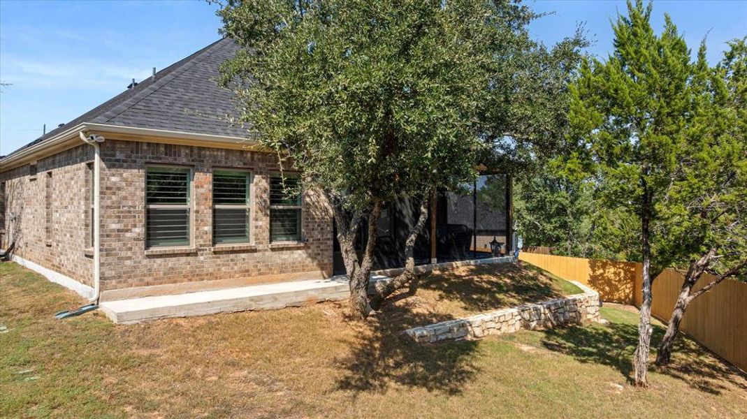 Rear view of property with brick siding, roof with shingles, and a patio area Rear view of property with brick siding, roof with shingles, and a patio area