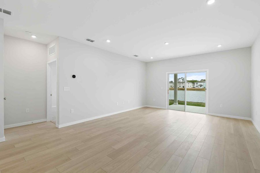 A room with white walls and a wood floor.