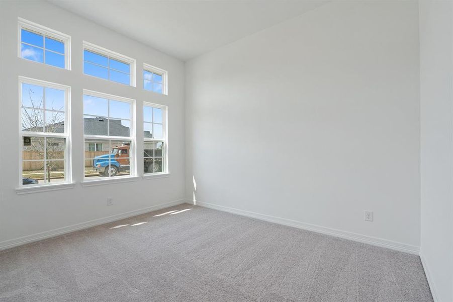 Your secondary bedroom features plush carpet, fresh paint, closet, and a large window that lets in plenty of natural lighting.