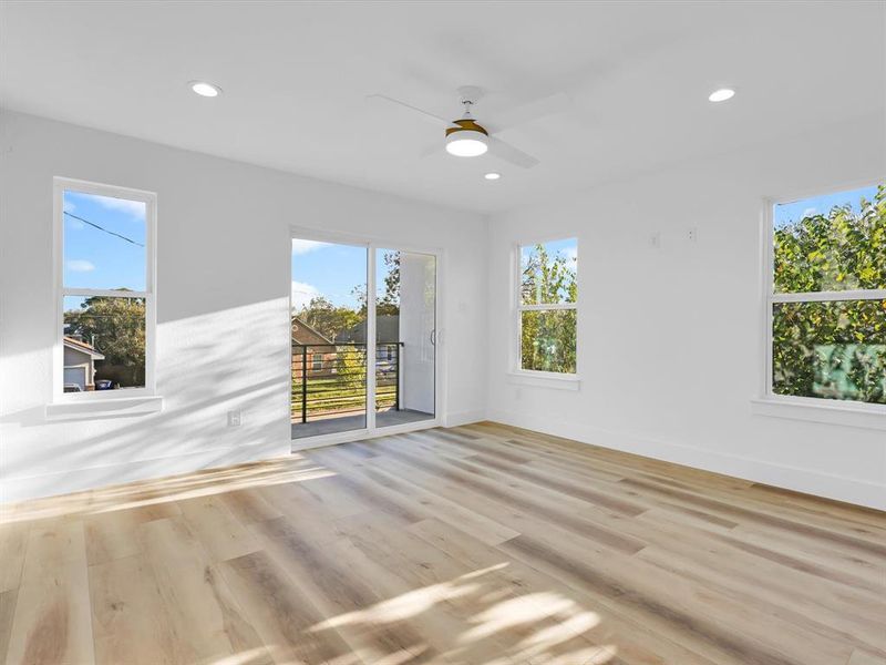 Unfurnished room with light hardwood / wood-style floors and a wealth of natural light