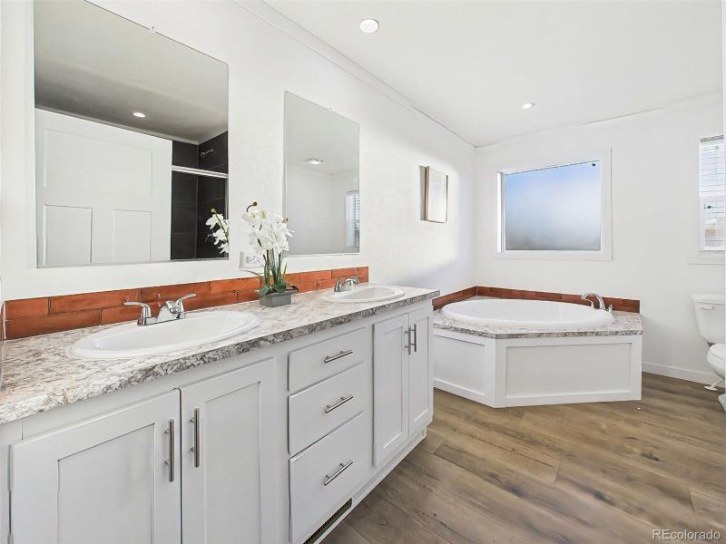 Featuring a 5-piece design, this spacious bath includes a dual-sink vanity, large soaking tub, and separate shower for added functionality.