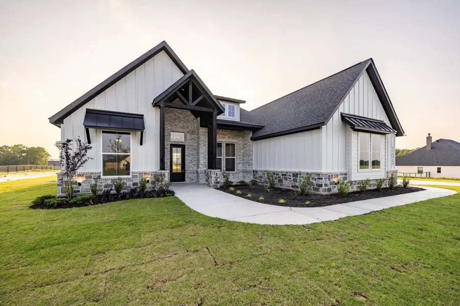 Front exterior of a new home in Prairie Winds Estates, Poolville, TX, highlighting curb appeal (Image 3). Front exterior of a new home in Prairie Winds Estates, Poolville, TX, highlighting curb appeal (Image 3).