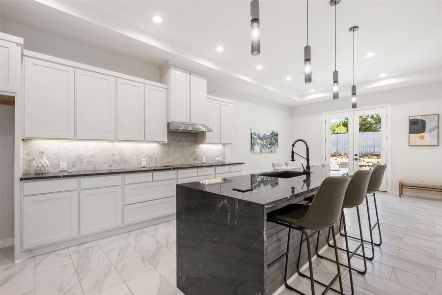 Beautiful white cabinets & custom lighting.